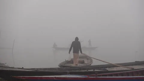 Some transporting wooden boat waits on the river on a foggy winter morning. Stock Footage 266197953