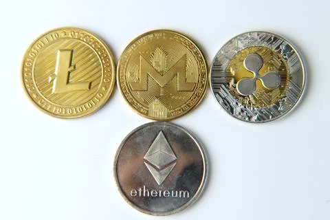 A some type of cryptocurrency on white background. Litecoin, Monero, Bitcoin. Stock Photos