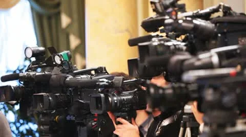 Some videocameras with operators close up recording presentation Stock Footage 10681694