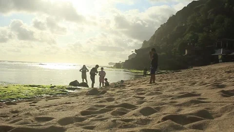 Some visitors play on the white sandy beach of Pok Tunggal Video stock 275271650