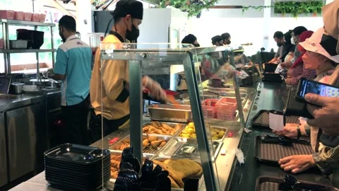 Some waiters with face mask serve some customers in a cafeteria. Stock Footage 168918206