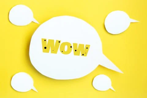 Some white paper speech bubbles with clipping path with inscription wow, on b Stock Photos