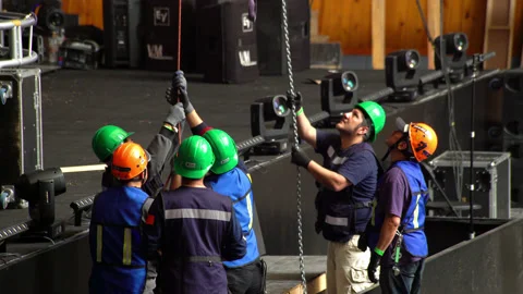 Some workers are pulling a rope to down a light Stock Footage 132448182