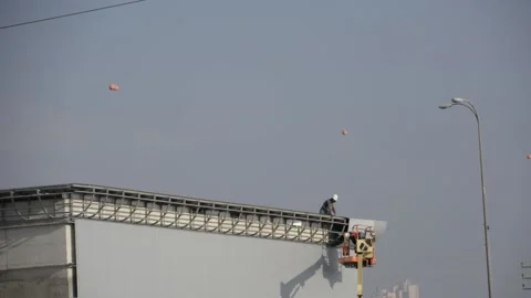Some workers on siding works look from distance 스톡 동영상 212526139