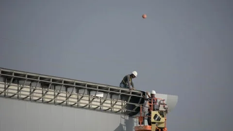Some workers on siding works look from distance 스톡 동영상 212526215