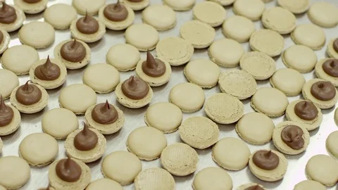 Some of yellow macarons' halves coated with cream Stock Footage 72332214