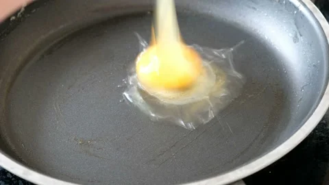 Somebody frying eggs on a pan, close up Stock Footage 103996393