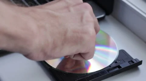 Somebody inserts CD disk into the disk drive Stock Footage 65372701