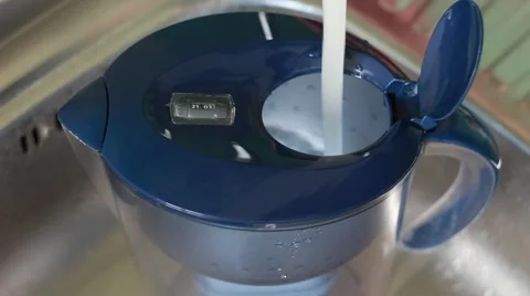 Somebody pours a water filter Stock Footage 64622652