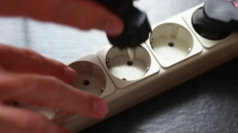 Somebody pulling a cable out from a socket 動画素材 64622308