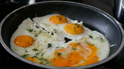 Somebody put fried eggs on a plate, close up Stock Footage 103997403
