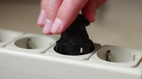 Somebody's hand inserts a cable into the socket Vidéo 64622391