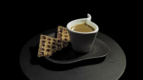 Someone adds marshmallows to dark waffles on a black plate. Stock Footage 101935309