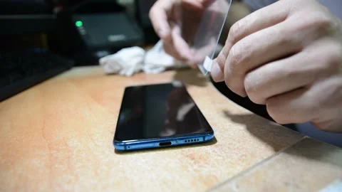 Someone changes the protective glass on a mobile phone Stock-Footage 139532999