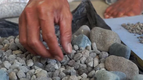 Someone is choosing pebbles to make art Stock Footage 205538243