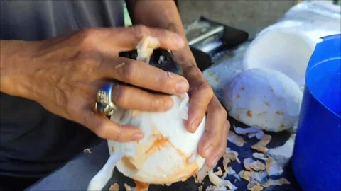 Someone cleaning a coconut Stock Footage 291638363