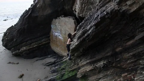 Someone climbing side of cliff Stock Footage 83162358