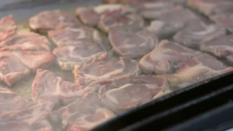 Someone is cooking a steak close up. Chef hands cooking steak in the kitchen. Video stock 196266318