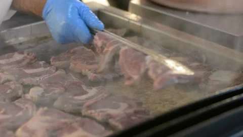 Someone is cooking a steak close up. Chef hands cooking steak in the kitchen. Video stock 196266319