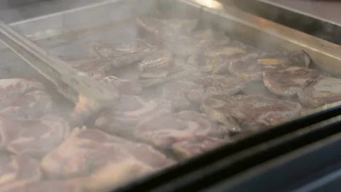 Someone is cooking a steak close up. Chef hands cooking steak in the kitchen. Video stock 196266324