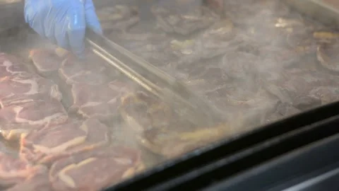 Someone is cooking a steak close up. Chef hands cooking steak in the kitchen. Video stock 196266349
