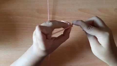 Someone crocheting starts making a magic ring Stock Footage 296612627