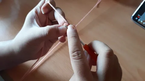 Someone crocheting starts making a magic ring Stock Footage 296612648