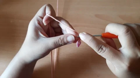 Someone crocheting starts making a magic ring Stock Footage 296612717