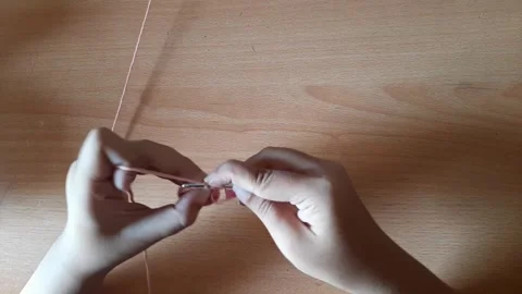 Someone crocheting starts making a magic ring Stock Footage 296612724