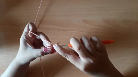 Someone crocheting starts making a magic ring Stock Footage 296612758