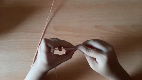 Someone crocheting starts making a magic ring Stock Footage 296612774