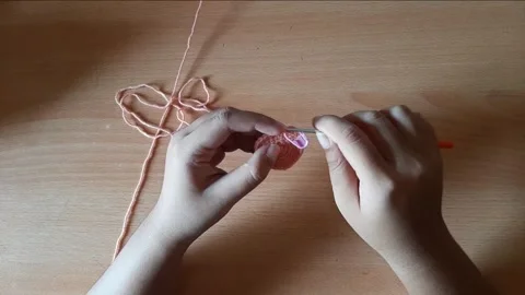 Someone crocheting starts making a magic ring Stock Footage 296612829