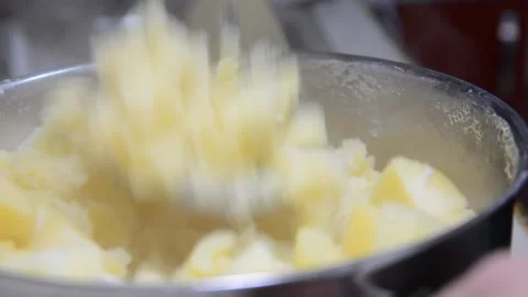 Someone crushes mashed potatoes close up soft focus. Video stock 139980678