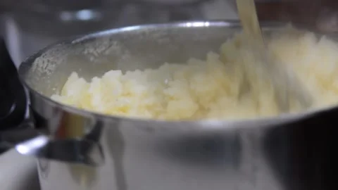 Someone crushes mashed potatoes close up soft focus. Видео 139980739