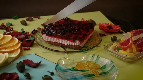 Someone cuts dessert with a big knife and puts a piece in a plate Stock Footage 113523595