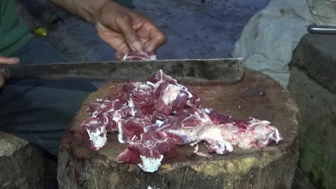 Someone cuts mutton with a machete Stock Footage 199024862