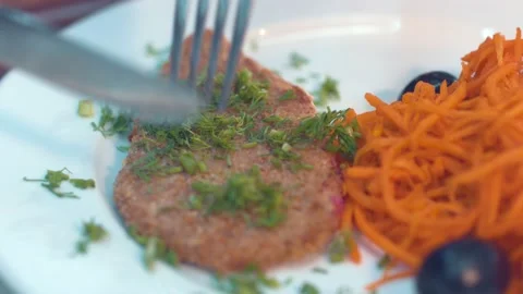 Someone cuts a piece of cutlets Stock Footage 134470032