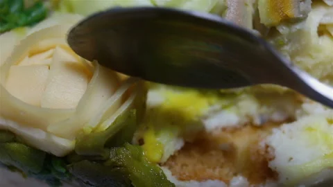 Someone cuts a Ranunculus flower with a teaspoon. Confectionery Floristics, edib Stock Footage 143598009