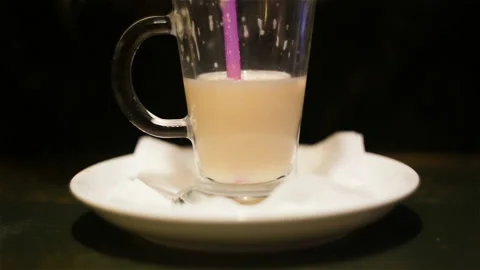 Someone drinks a latte coffee to the bottom close-up of a tube, a glass glass Cu Stock Footage 99508405