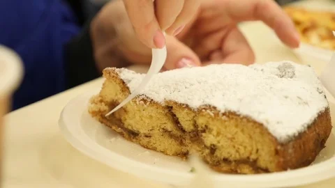Someone eats a dried cake in a cafe of disposable dishes. 4k slow motion. Stock Footage 82410156