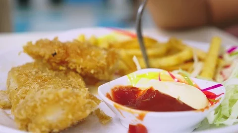 Someone eats Fast food, fried crispy and spicy strips and french fries with salt Stock Footage 100259265