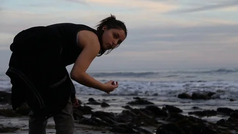 Someone finds shells to collect Stock Footage 83174229