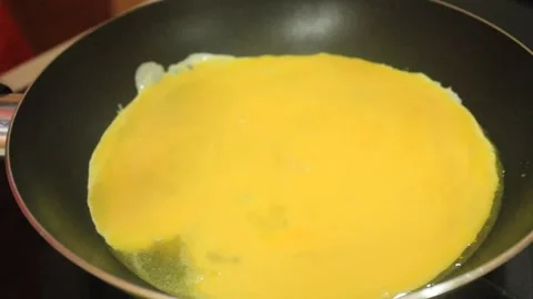 Someone fried a beaten egg. Cooking fried eggs Stock Footage 334268518