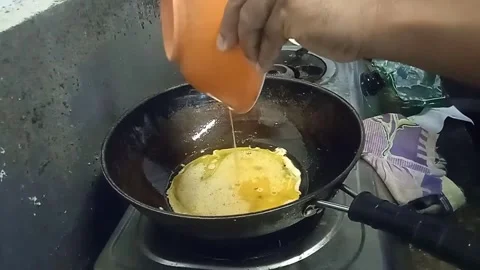 Someone is frying eggs in the kitchen. Stock Footage 304337572