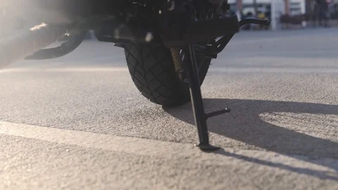 Someone gets on a motorcycle and removes the support stand. Stock Footage 103183308