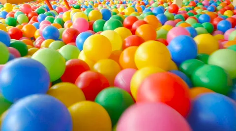 Someone goes on the colored ball in the children's play pool Stock Footage