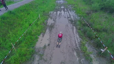 Someone is going across the mud puddle bit by bit Stock Footage 63766008