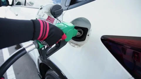Someone hand holding nozzle for refueling car from gas station or petrol 库存影片 336569777