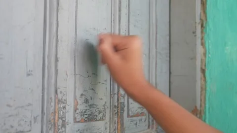 Someone hand was knocking on the old gray wooden door with a fist Stock Footage 332866964