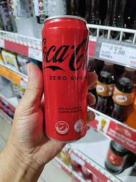Someone is holding a zero-calorie, zero-sugar coca cola drink Stock Photos
